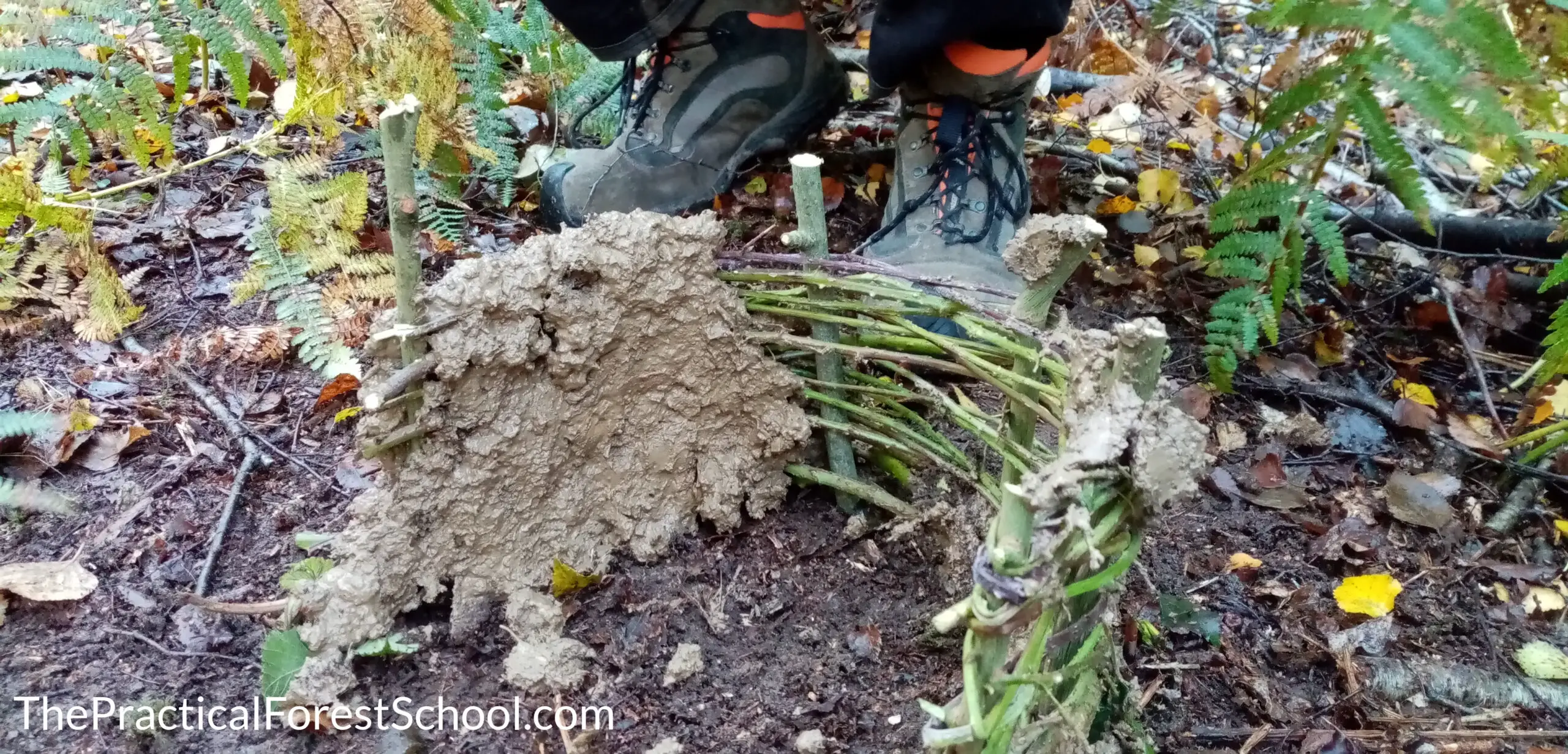 Using sticks and mud to make a mini home for minibeasts