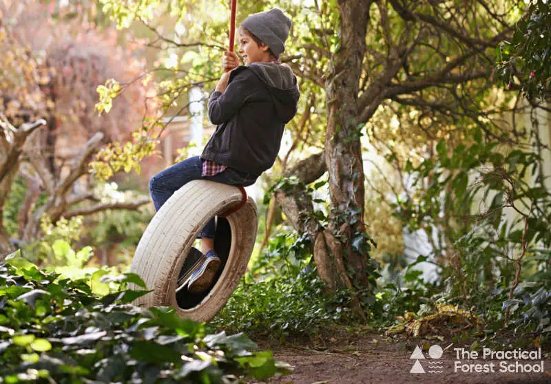 Throwing a Forest School Party: Ideas for Games, Food, and Fun! 4 boy on a tyre swing