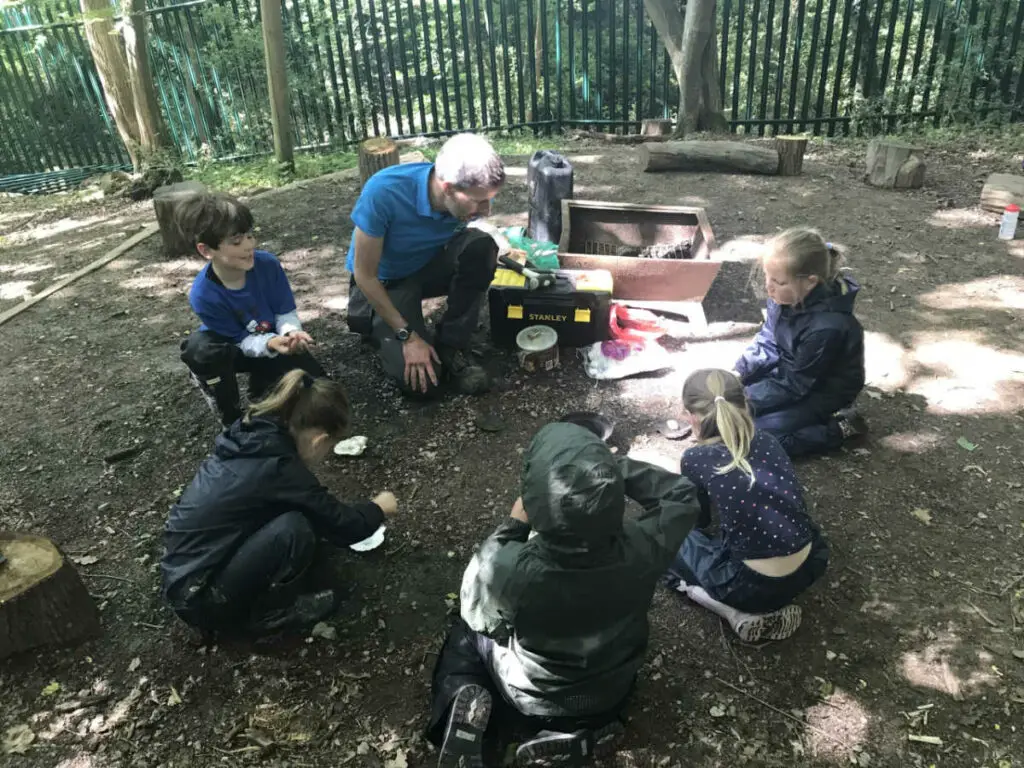 Jon showing a group of Year 3 children how to make fairy fires.