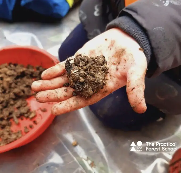 Child holding mud ball
